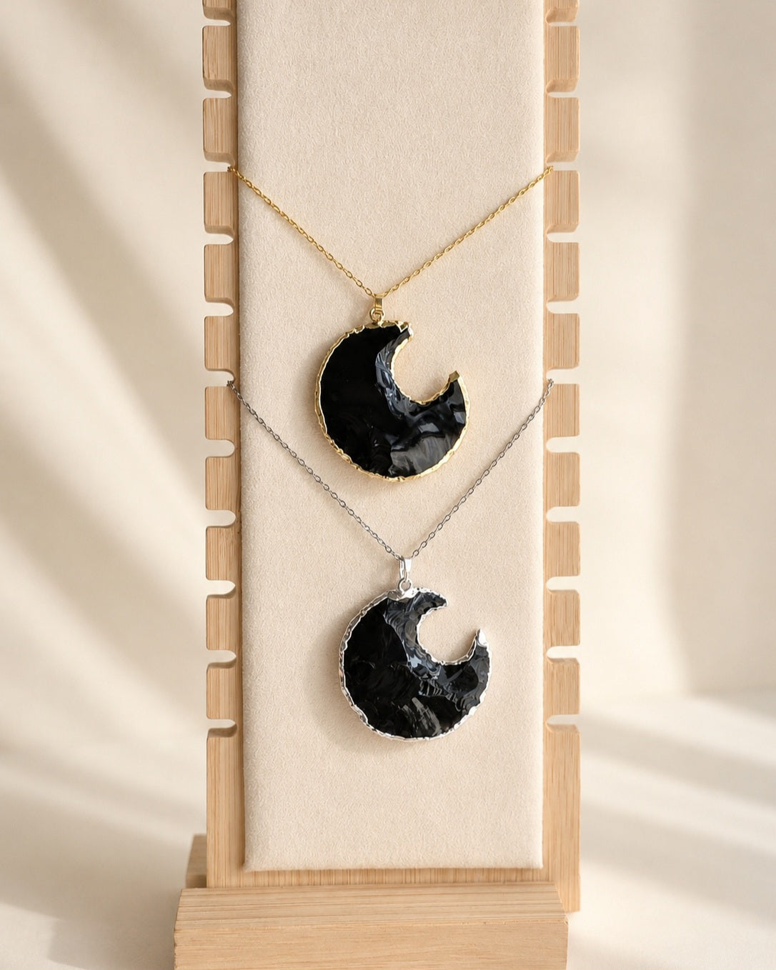 Black Obsidian crescent moon pendant necklace in gold.