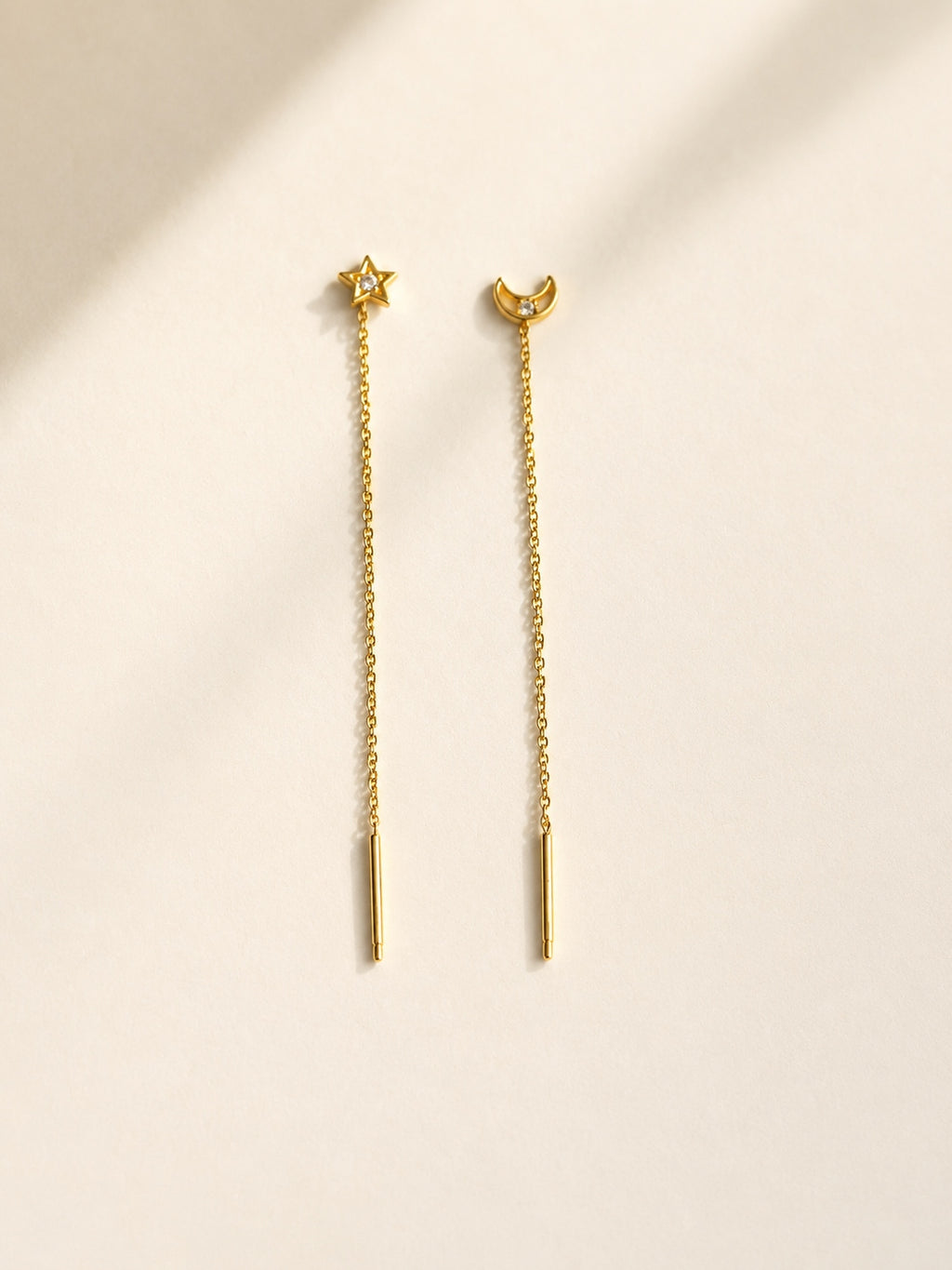 Silver celestial threader earrings featuring moon and star charms.