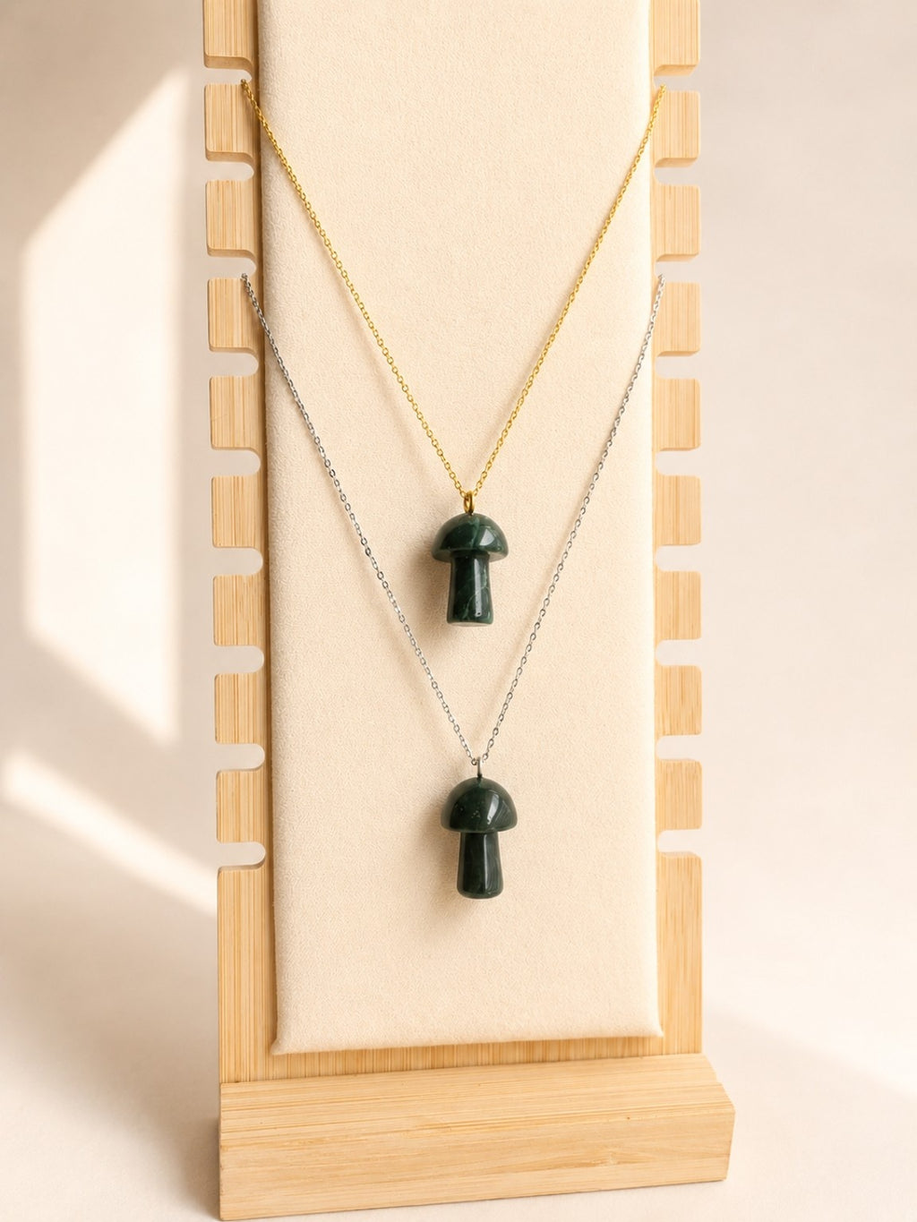 Mushroom-shaped Moss Agate pendant on a gold-plated necklace.