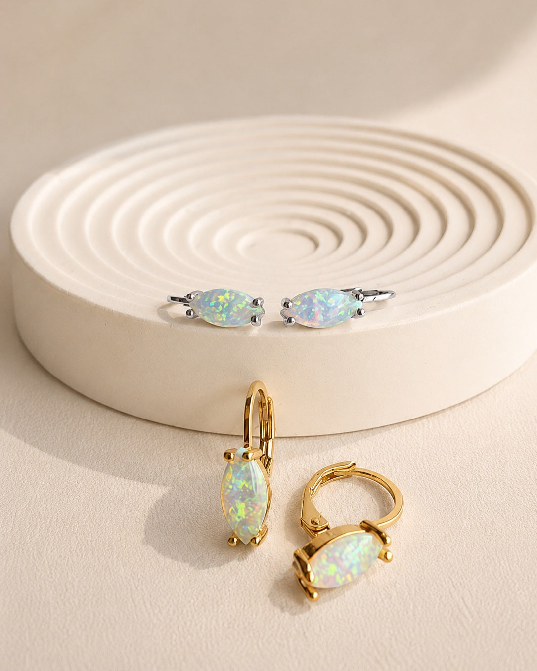 Marquise opal huggie earrings with a 14K gold-plated finish and white fire opals.