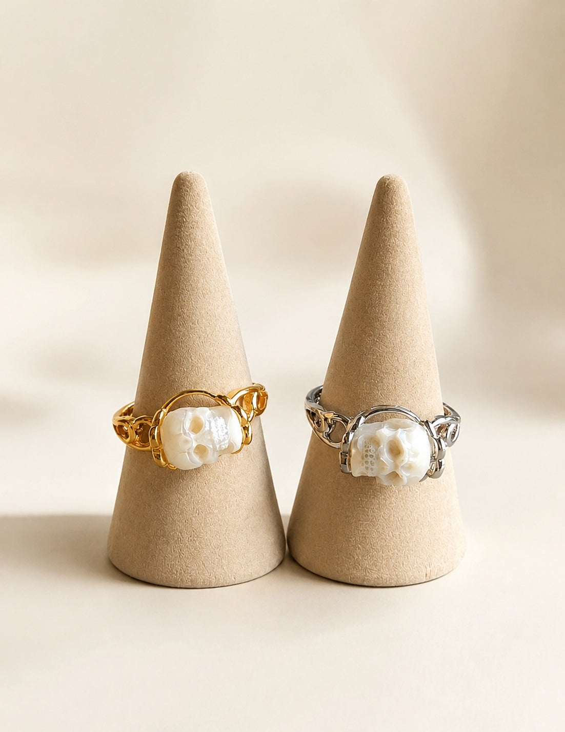 Pearl skull ring jewelry in gold and silver on display.