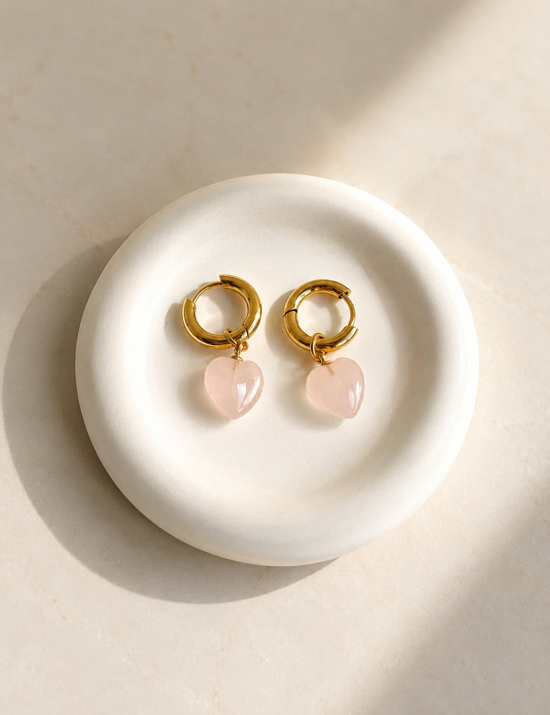 Rose quartz heart drop earrings with 18K gold plating and a non-tarnish finish.