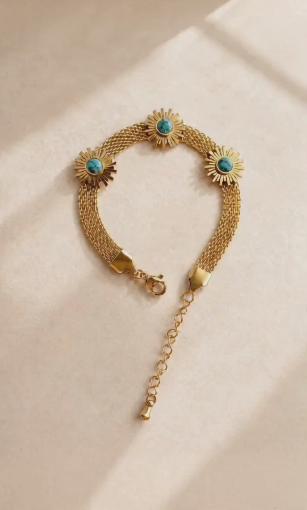 Gold sunflower bracelet with a turquoise-colored centerpiece for everyday wear.