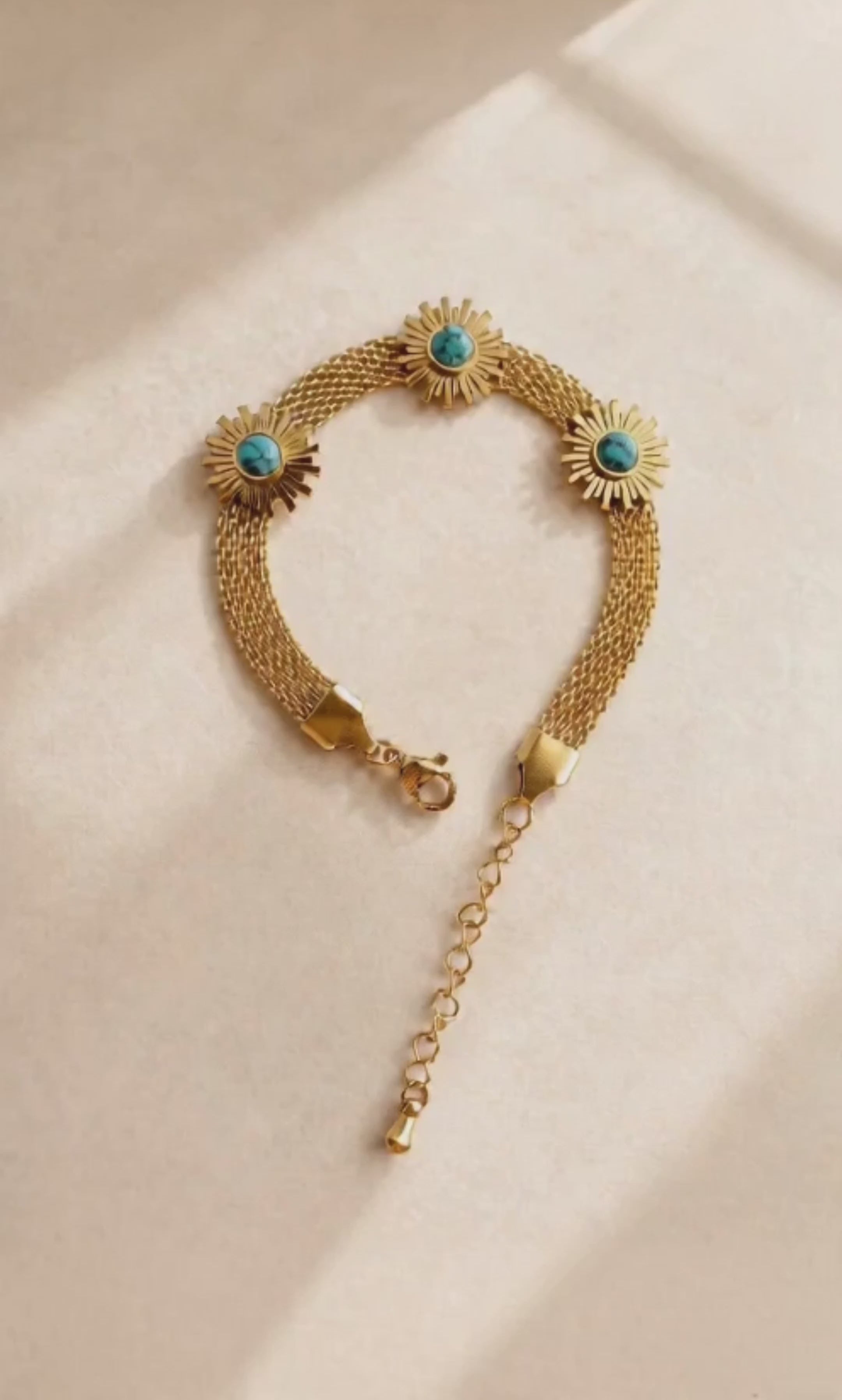 Gold sunflower bracelet with a turquoise-colored centerpiece for everyday wear.