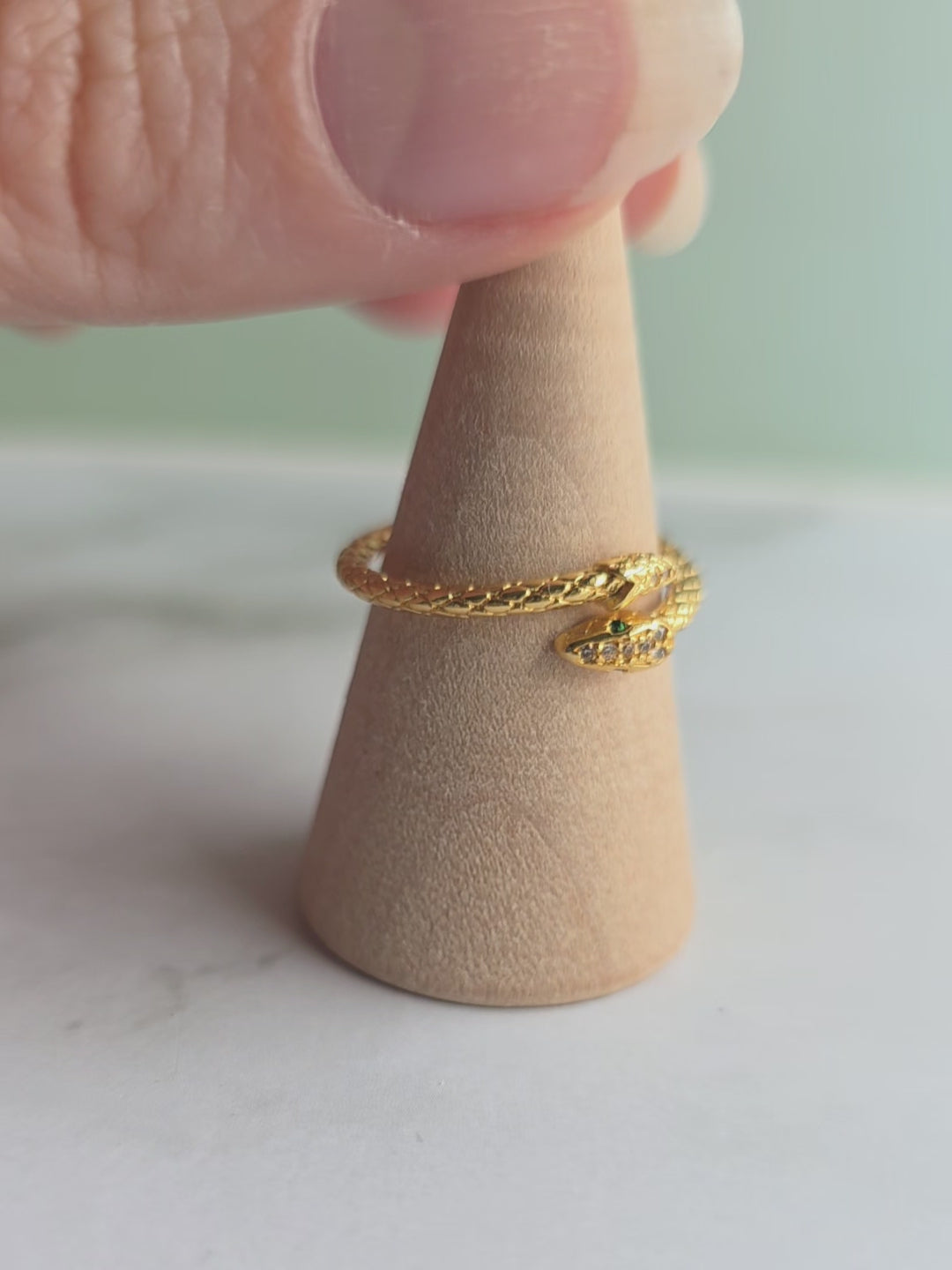 Adjustable snake wrap ring with 18K gold plating and sparkling CZ accents.
