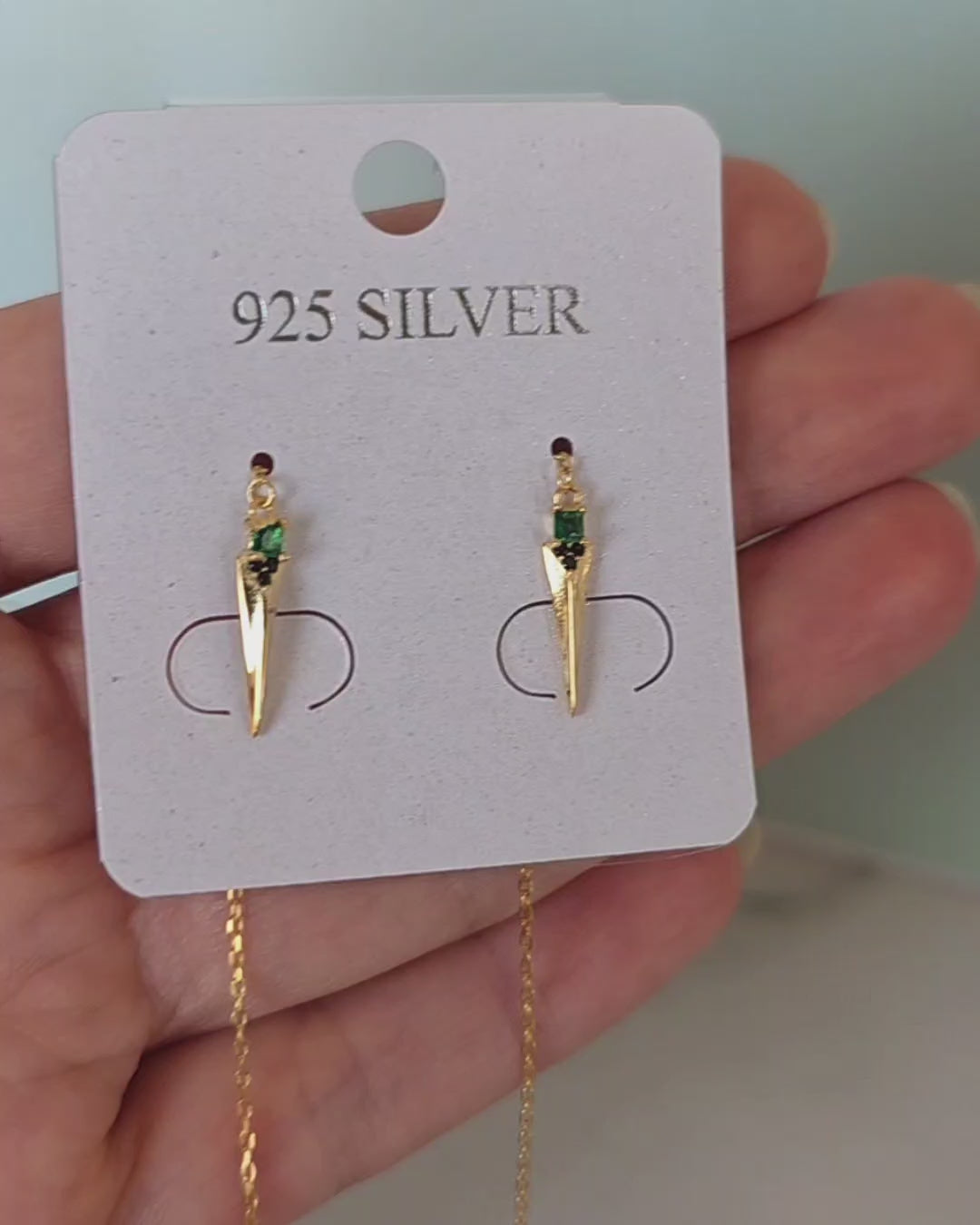 Women's emerald threader earrings with elegant chain drops and pointed spike pendants.