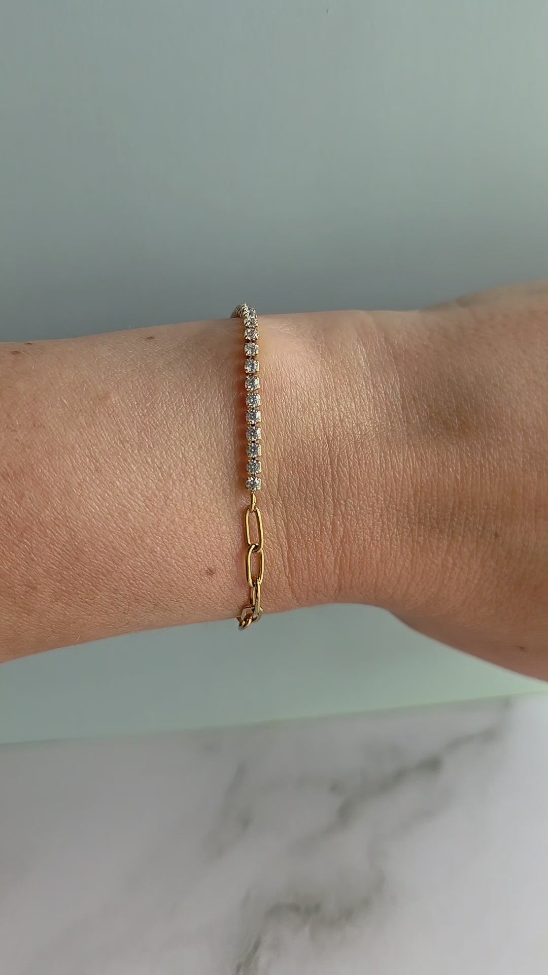 Non-tarnish paperclip tennis bracelet in 18K gold plating.