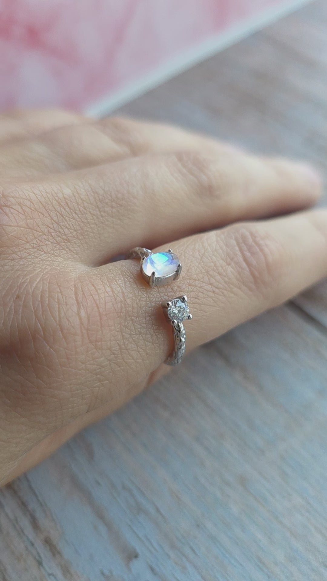 Gold-plated rainbow moonstone ring featuring a textured hammered band.