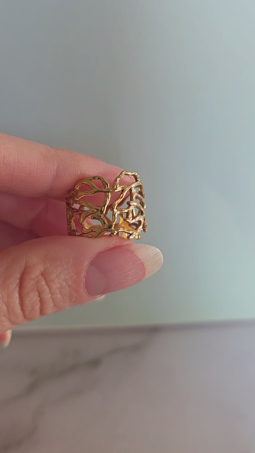 14K gold-plated statement ring with an organic sculptural silhouette.