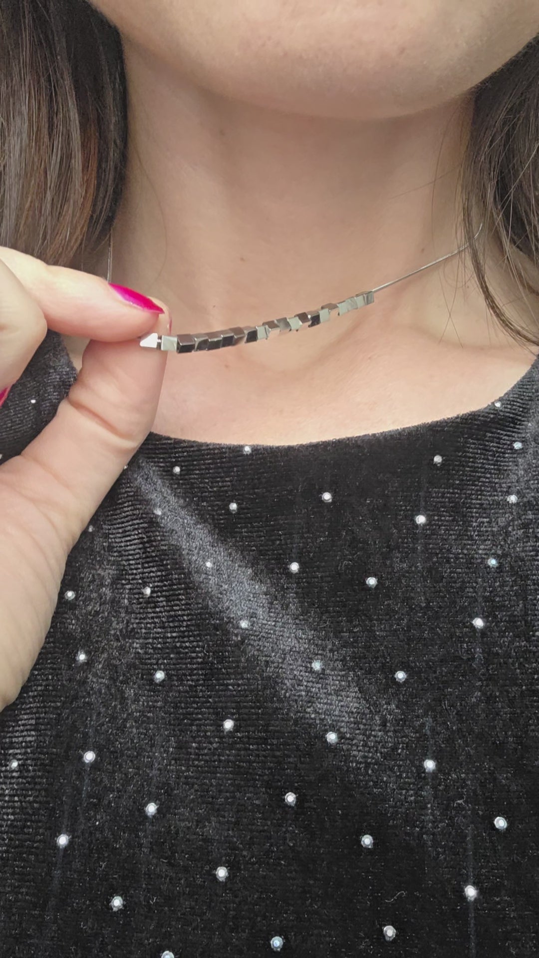 Gold-plated cube pendant necklace with a modern spinning bead design.