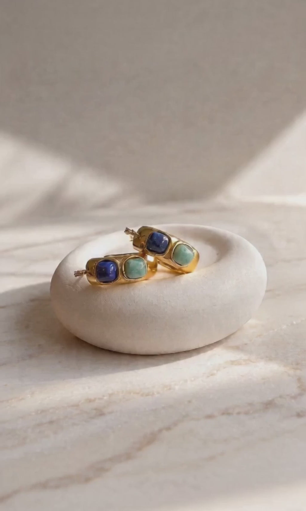 Chunky gemstone hoop earrings with natural turquoise and polished gold-plated hoops.