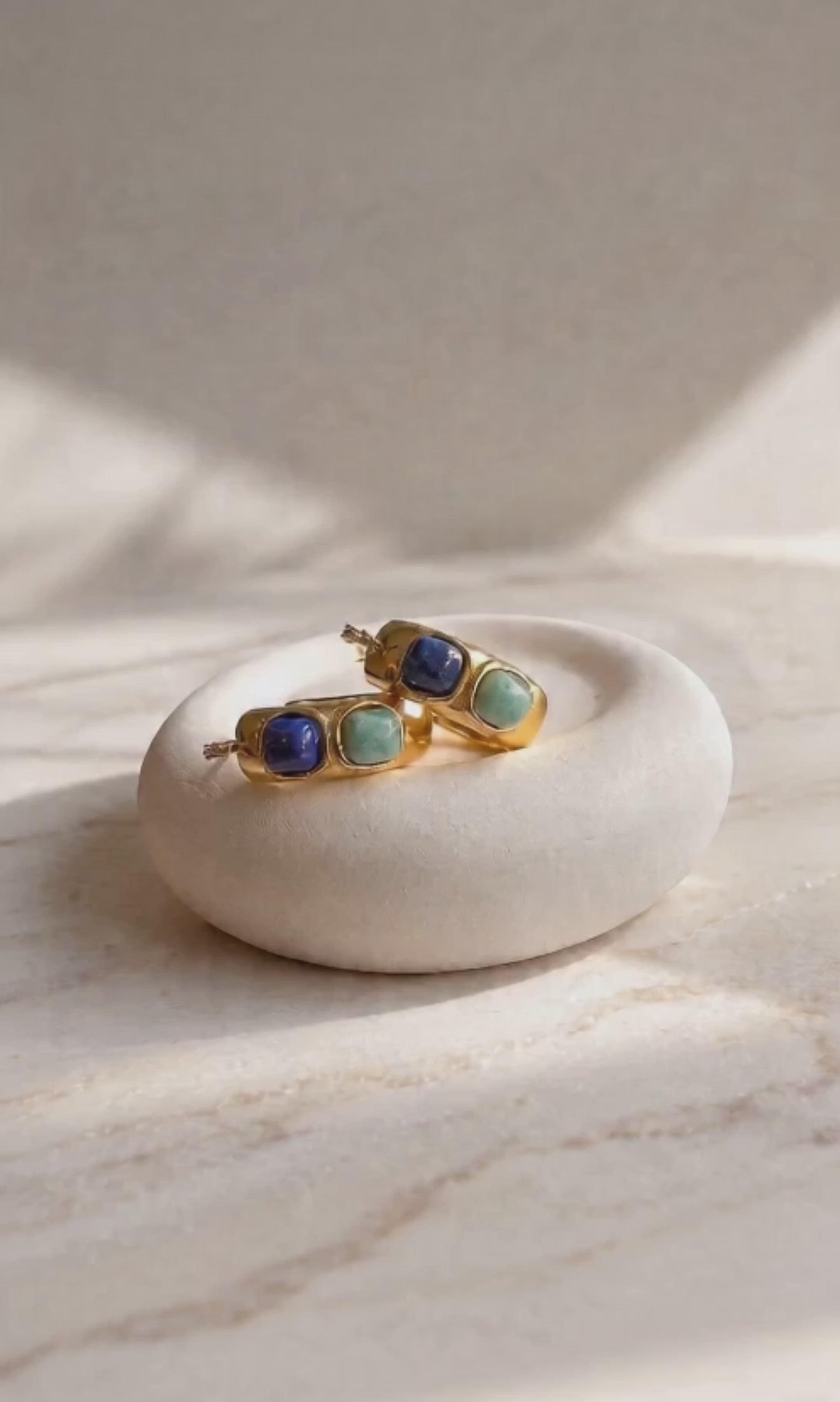 Chunky gemstone hoop earrings with natural turquoise and polished gold-plated hoops.