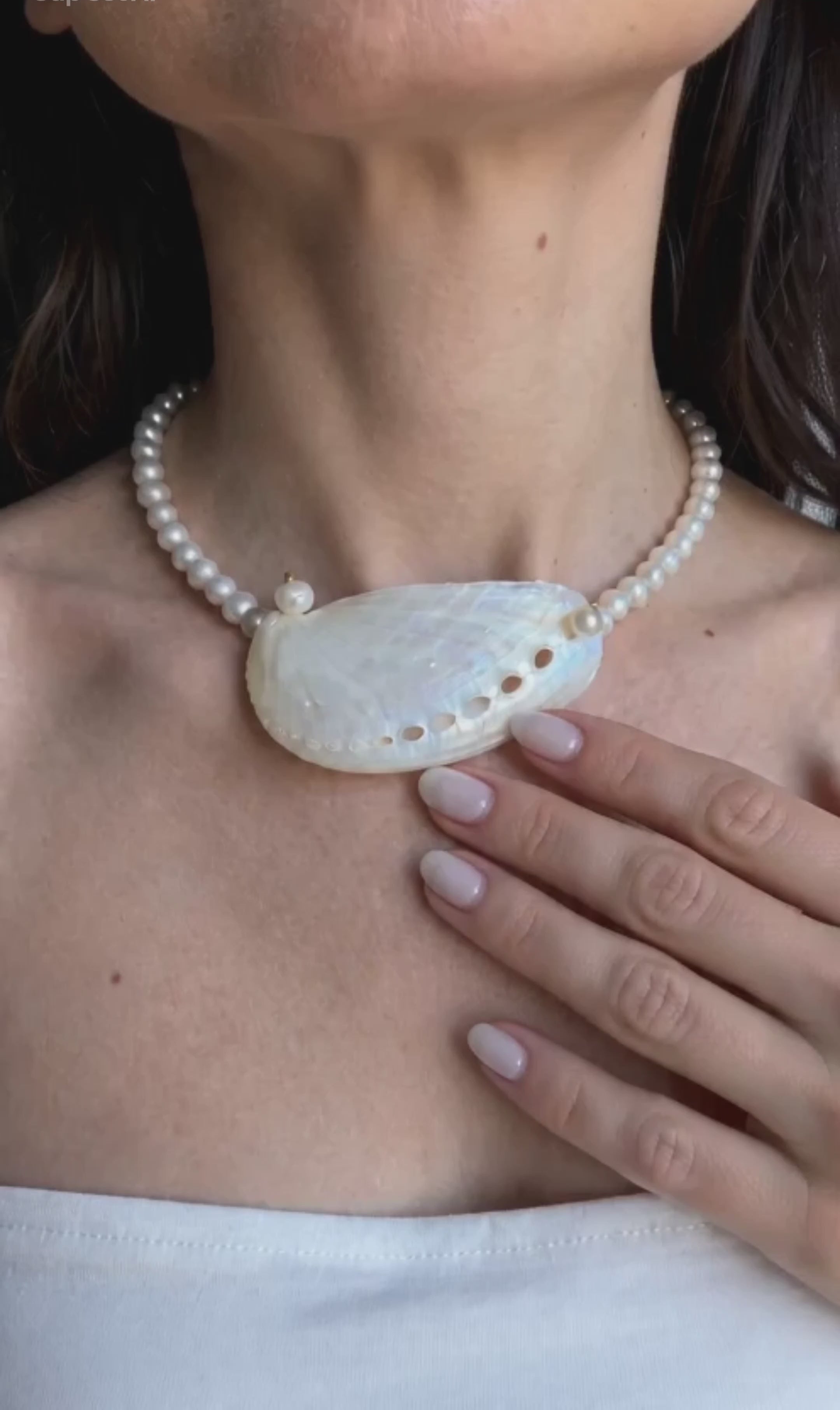 Coastal pearl necklace with a seashell charm for everyday and vacation wear.