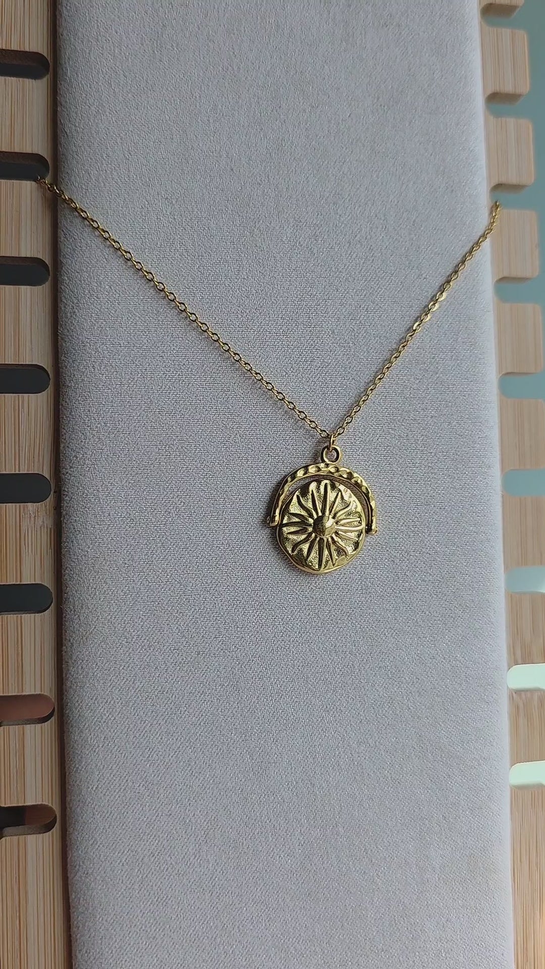 Sun and moon necklace with a movable spinner pendant.