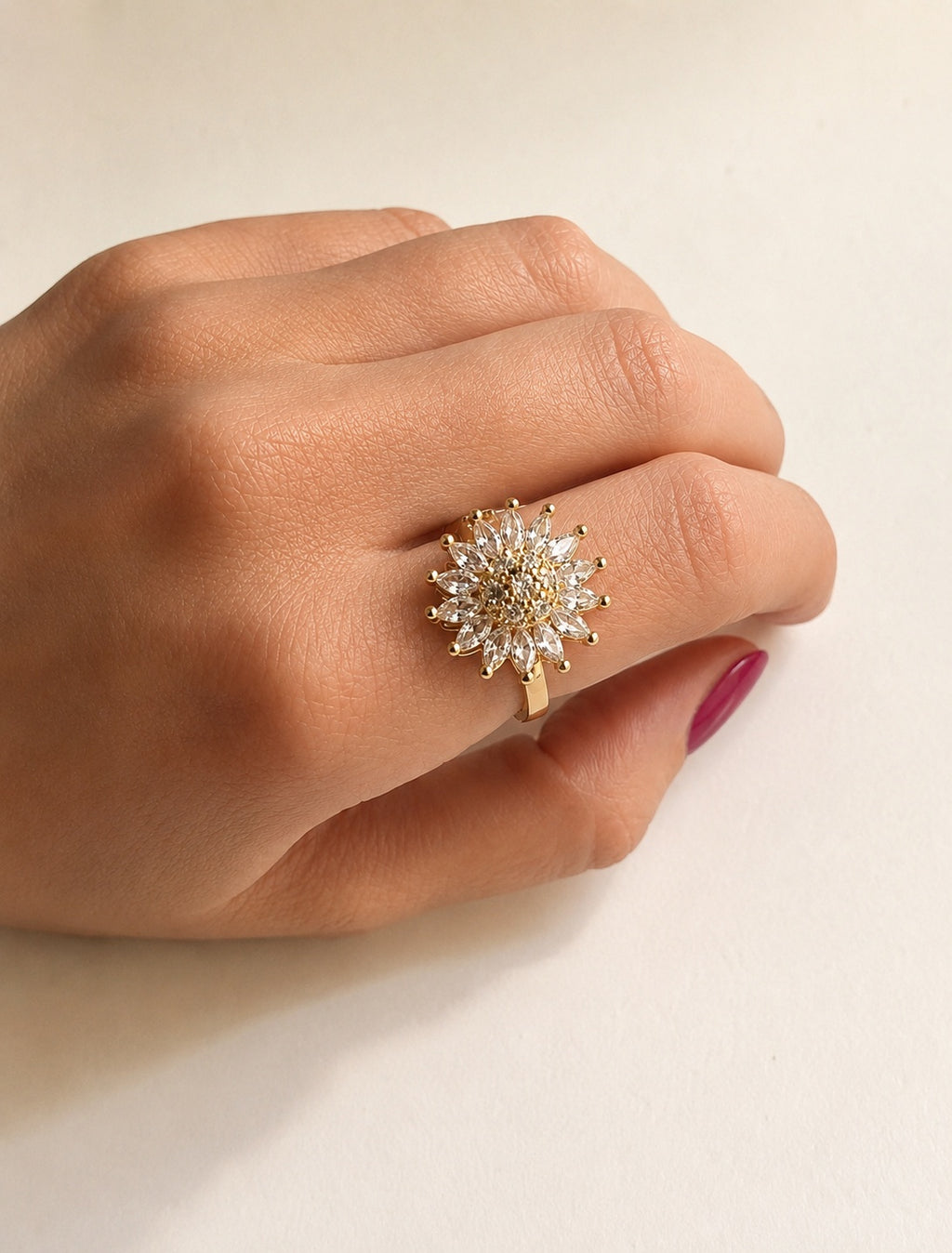 Flower fidget spinner ring with a 14K gold-plated adjustable band.