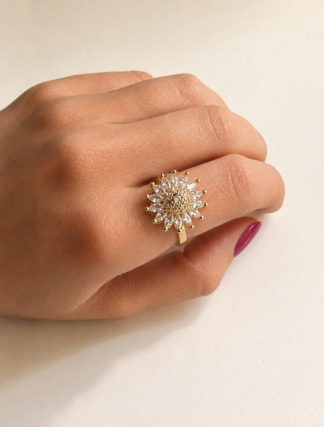 Flower fidget spinner ring with a 14K gold-plated adjustable band.