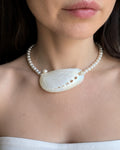 Real pearl choker necklace with a natural seashell pendant and coastal design.