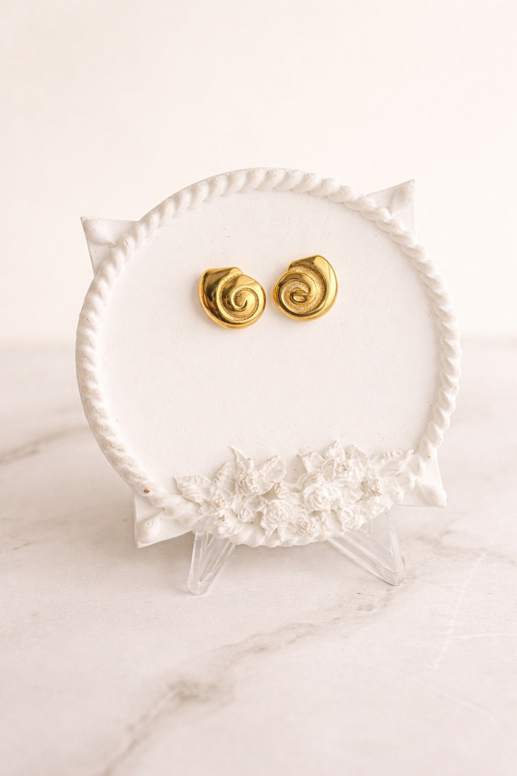 18K gold-plated spiral stud earrings with a polished modern design.