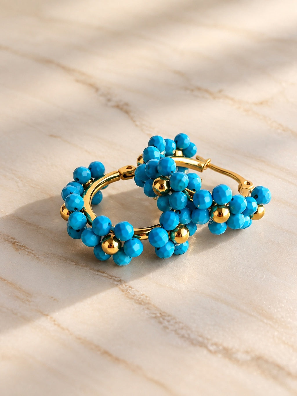 Gold hoop earrings with turquoise blue beads