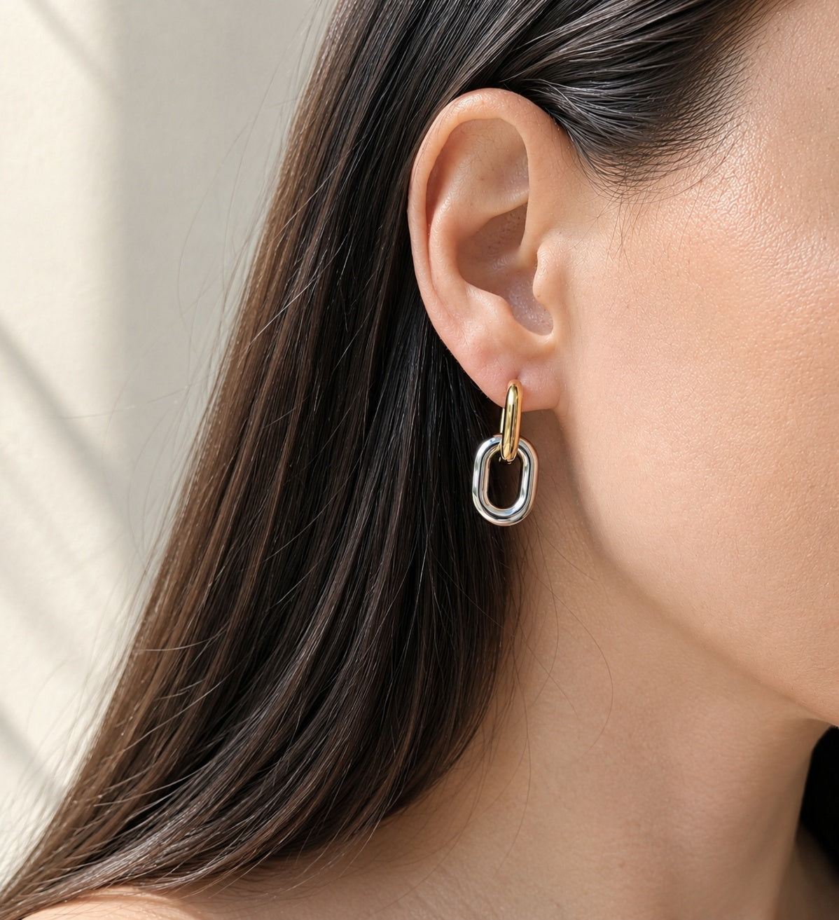 18K gold-plated and silver stainless steel huggie hoop earrings.
